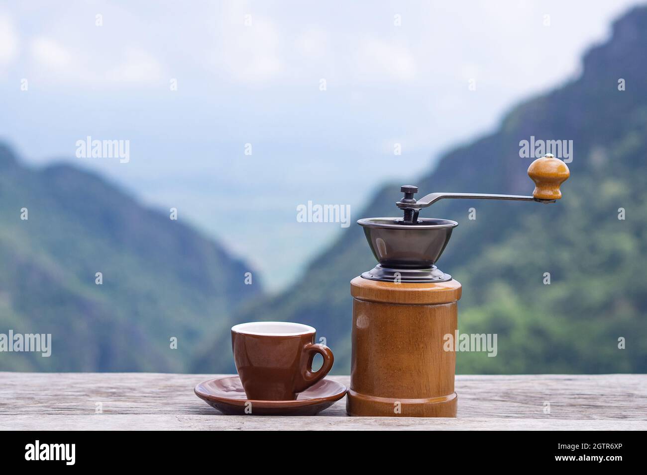 Manual Coffee Grinder And A Coffee Cup 