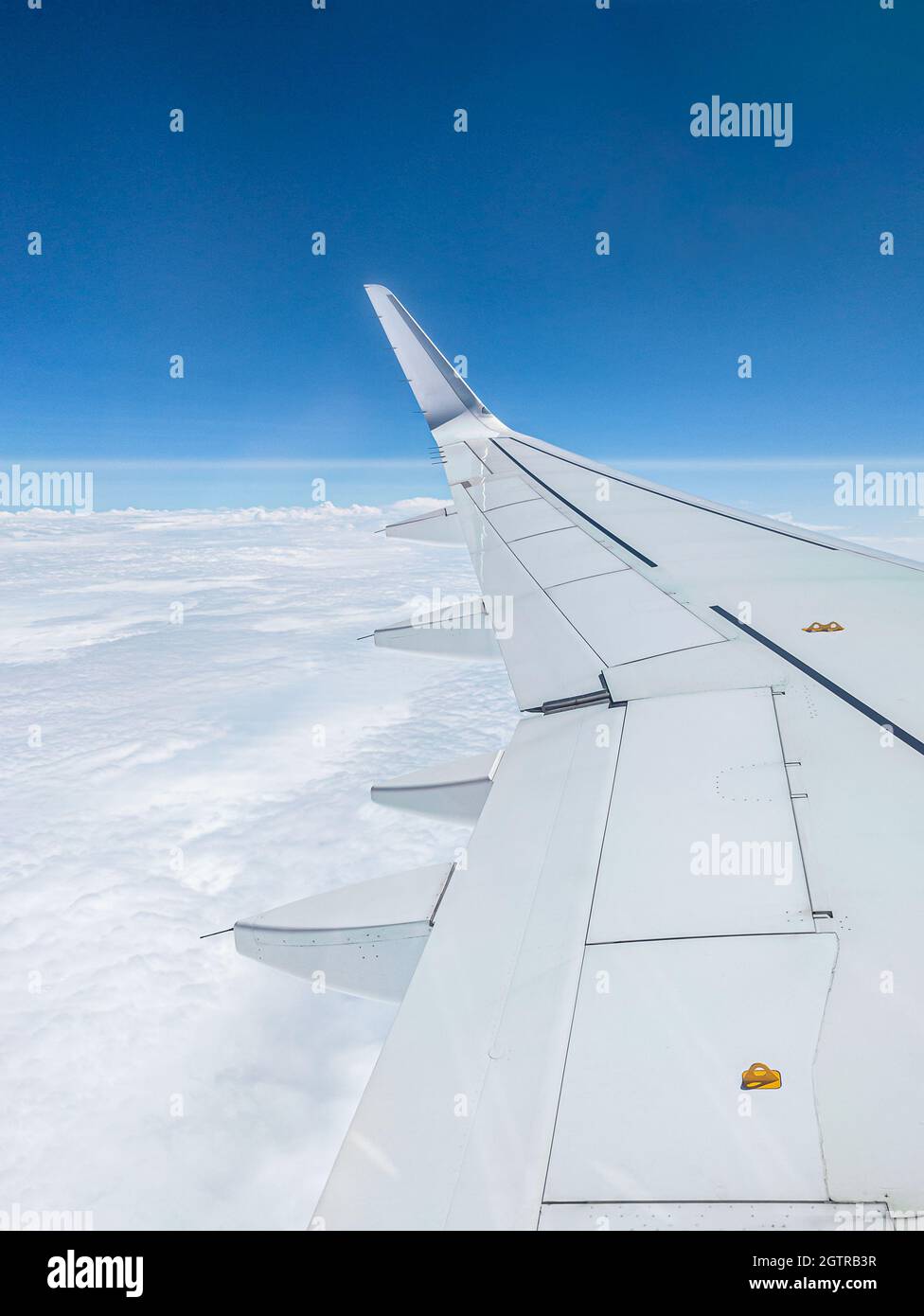 Air Plane wing on the blue sky and clouds Stock Photo