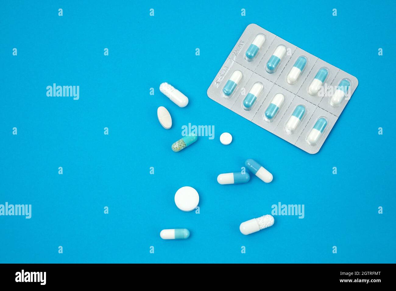 High Angle View Of Medicines Over Blue Background Stock Photo