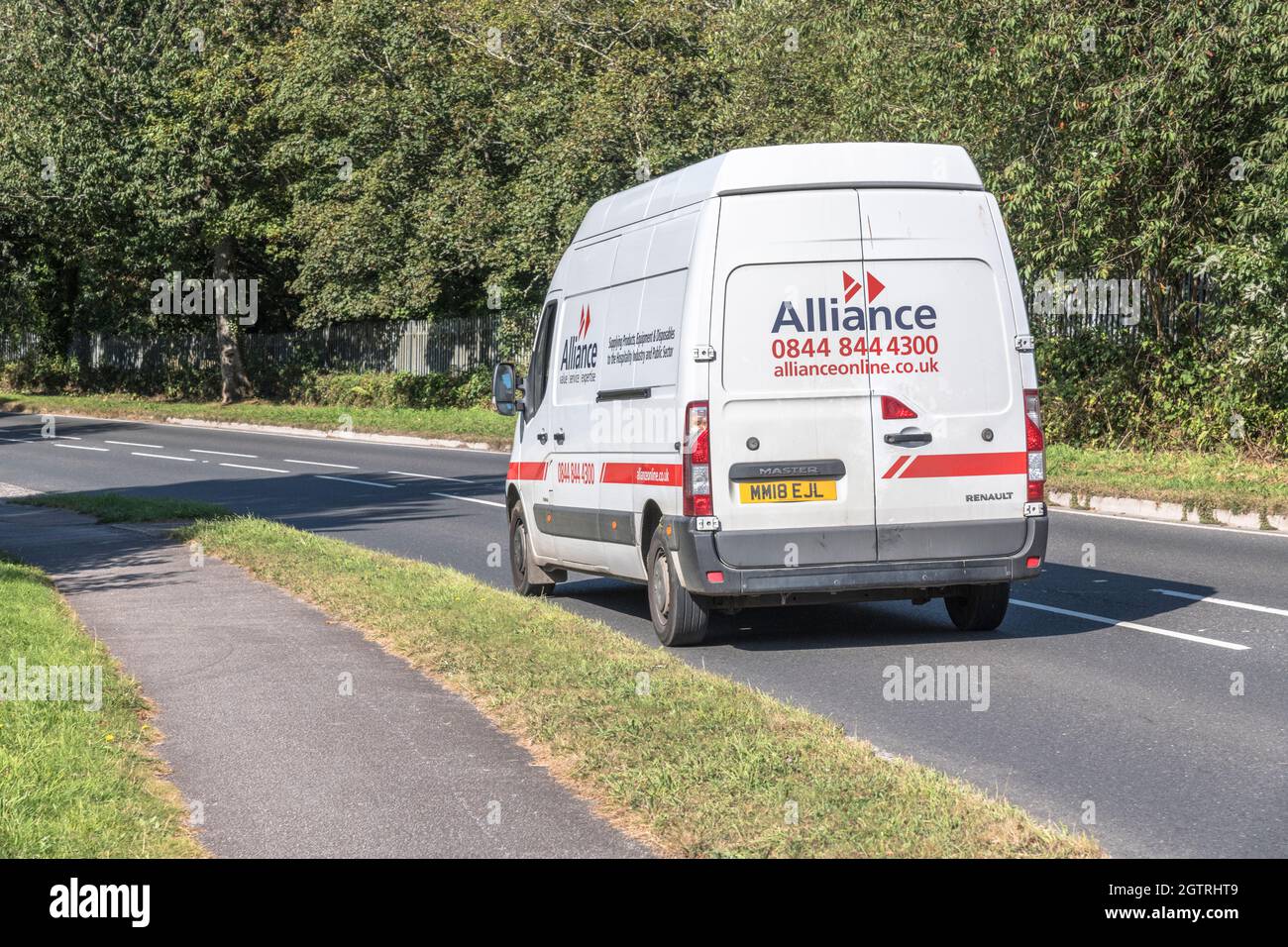 Alliance catering supplies Renault delivery van going downhill on country road. For UK driver shortage, goods delivery during Covid, UK transport Stock Photo