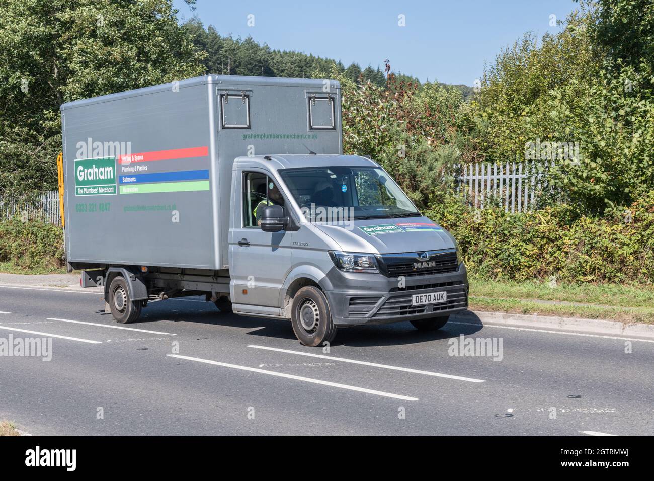 Graham plumbing supplies / merchant MAN delivery truck going uphill on country road. For UK driver shortage, goods delivery during Covid, UK transport Stock Photo