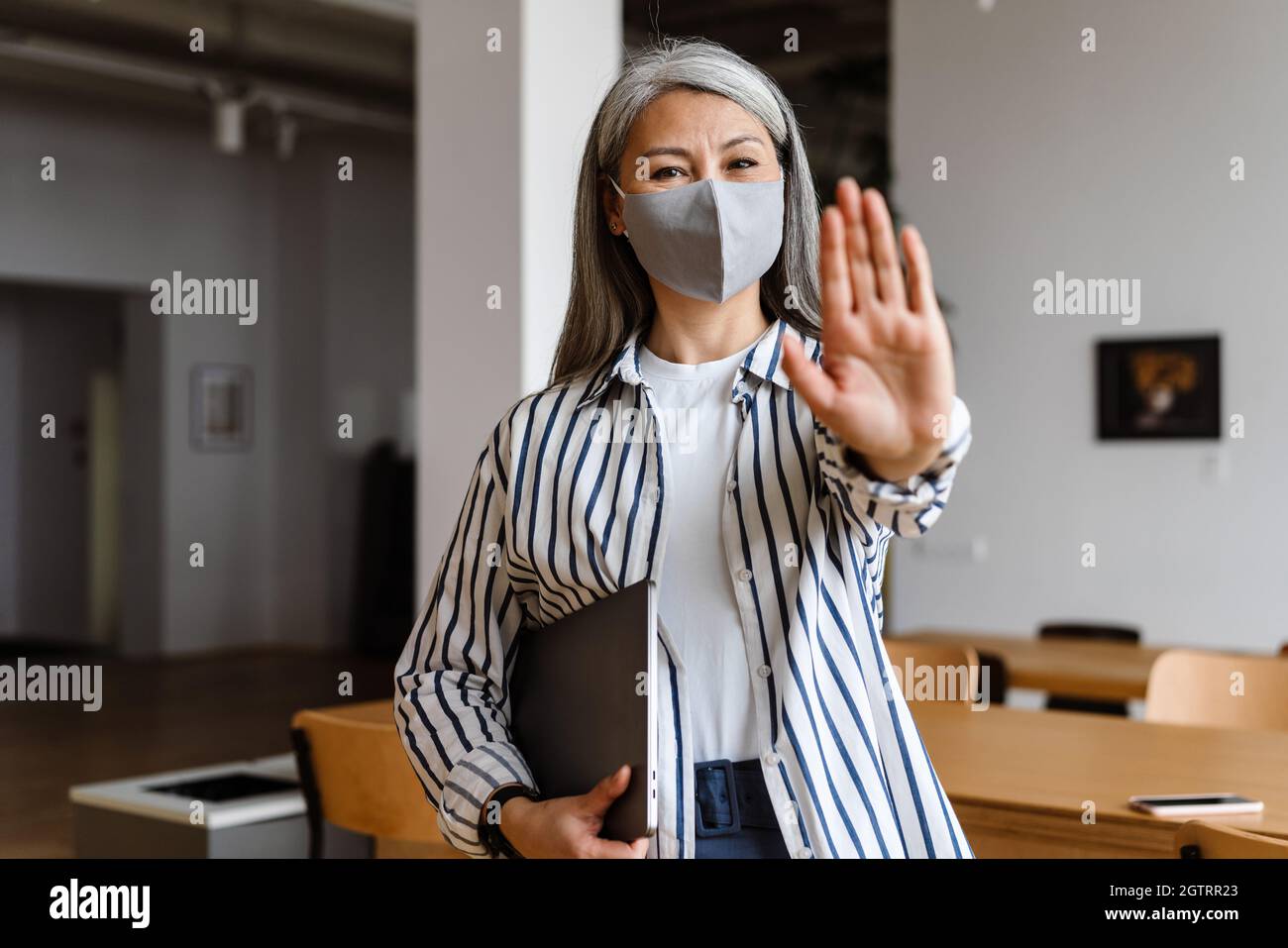 Mature woman showing stop sign hi-res stock photography and images - Alamy