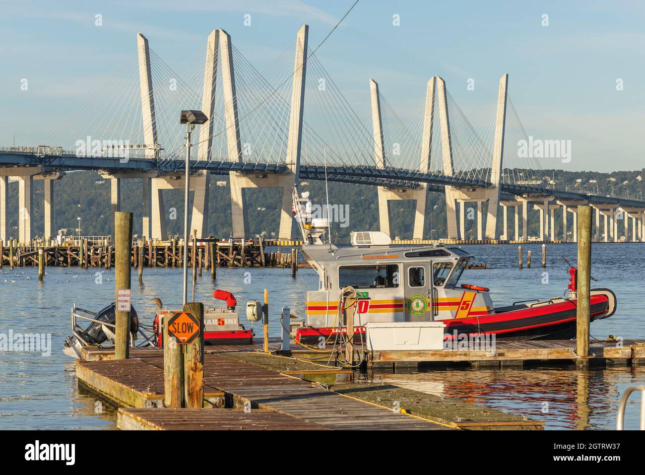Tarrytown Fire Department fire-rescue boat 'Chief John Kelly' docked on the Hudson River, with the Governor Mario M. Cuomo bridge in the background. Stock Photo