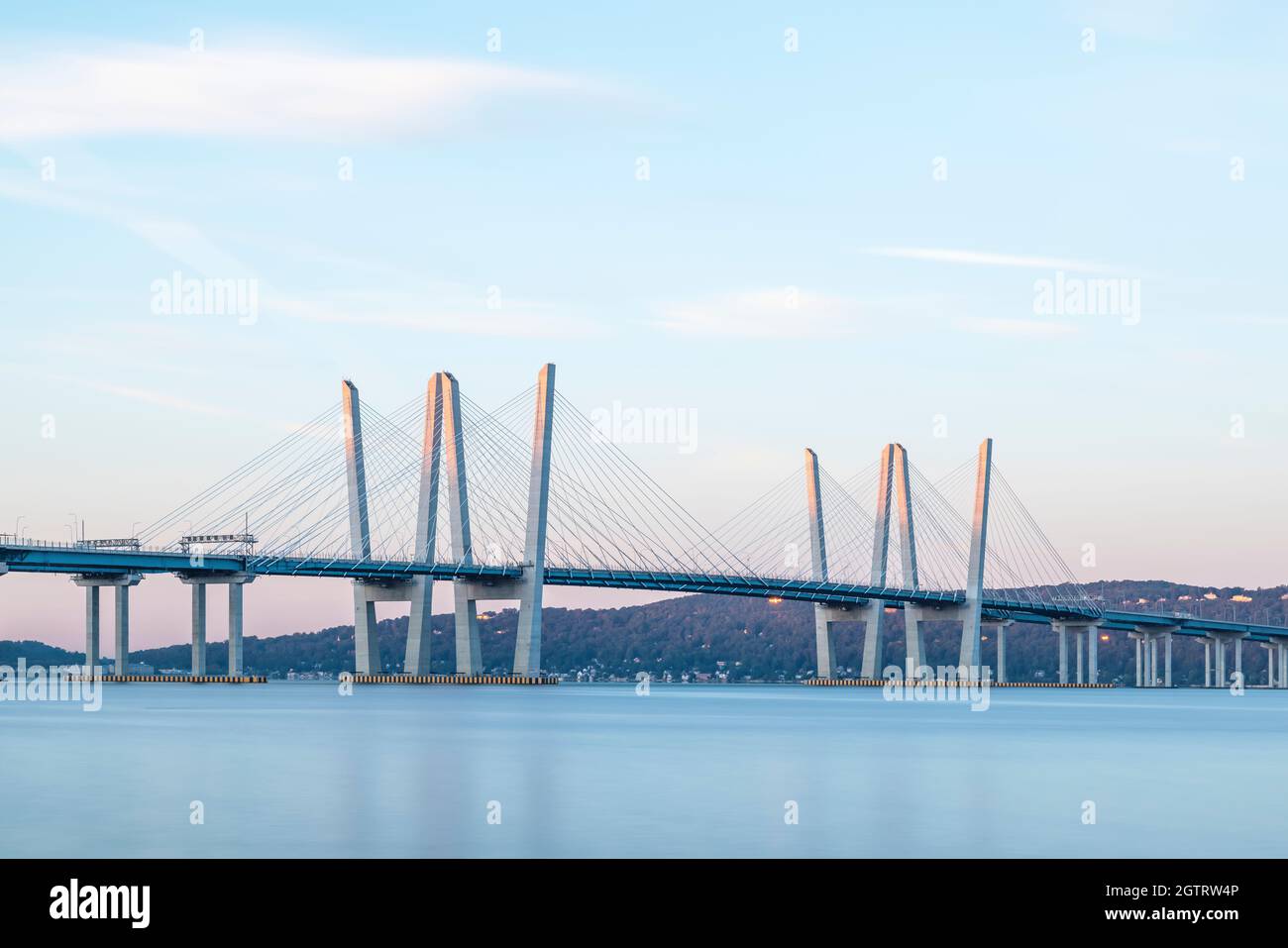 The rising sun lights the tops of the towers of the Governor Mario M. Cuomo Bridge just after sunrise. Stock Photo