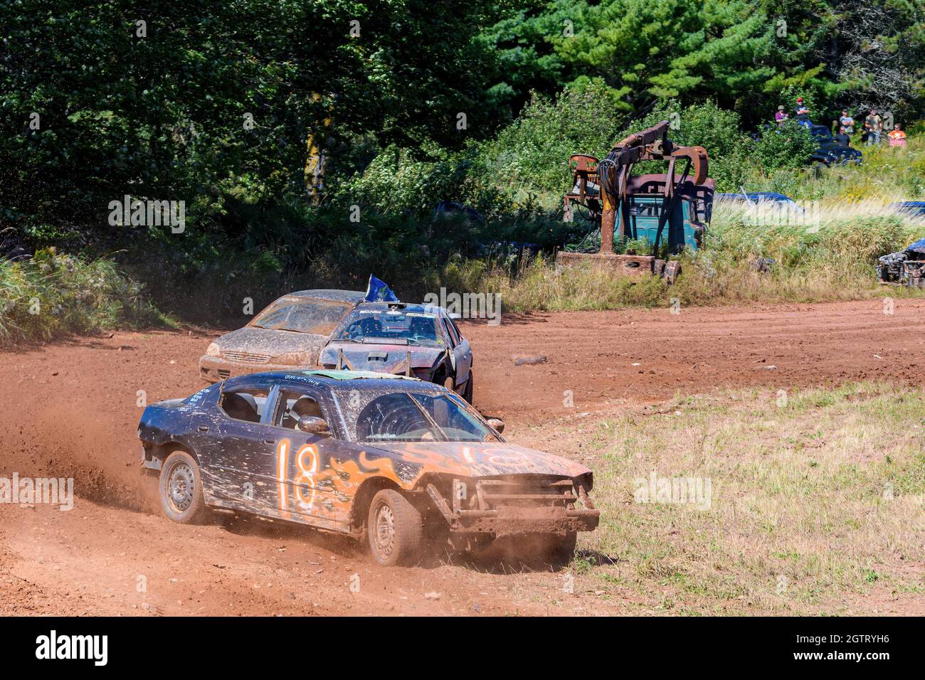 Norton, NB, Canada - September 11, 2021: Dirt track racing at the Redneck Raceway. Three cars slide around a corner at one end of the track. Stock Photo