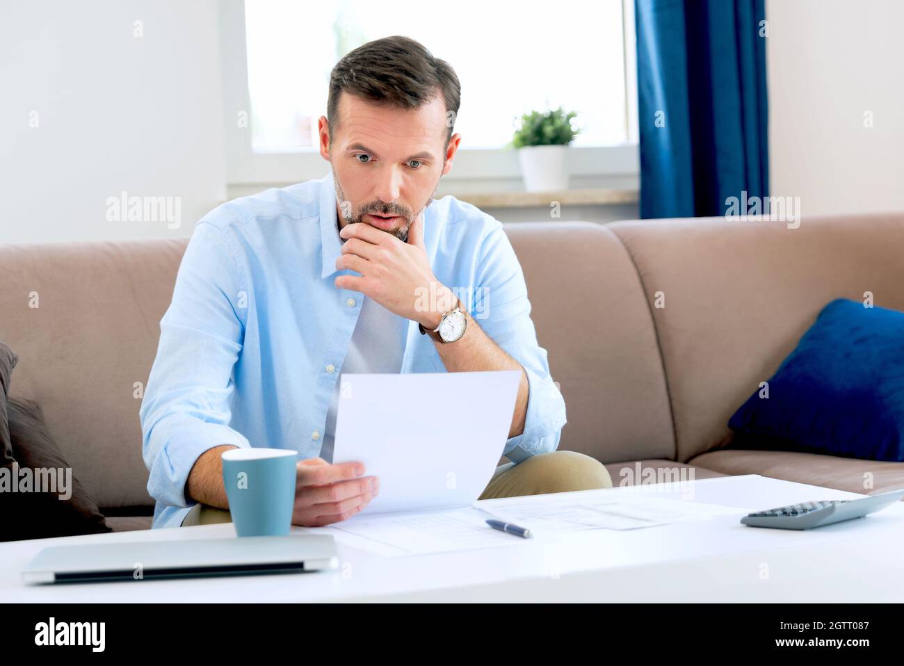 Man sitting at the table. Home budget, finances concept Stock Photo