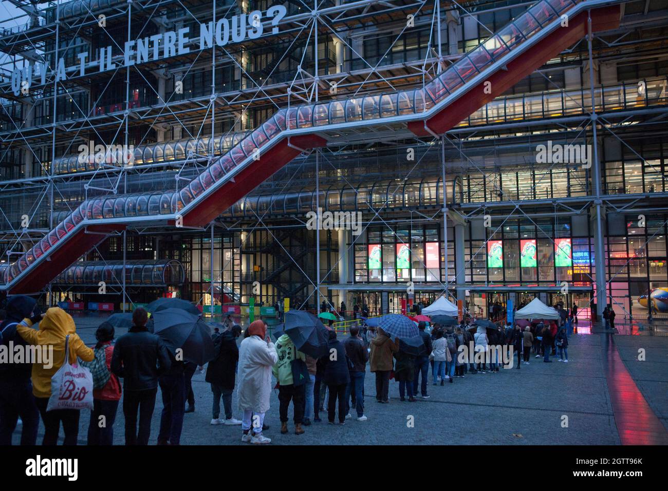 Paris, France, 2 October 2021: the annual Nuit Blanche in Paris, when public museums stay open late into the night and have free entry, still attracted a crowd of art enthusiasts at the Centre Georges Pompidou despite heavy rain and stormy conditions. For adults entry to all public spaces such as museums and restaurants requires a Pass Sanitaire (health pass) as proof of being double vaccinated to be shown on the TousAnticovid app. From Thursday 7 October this requirement will be extended to 12 to 17 year olds. Anna Watson/Alamy Live News Stock Photo