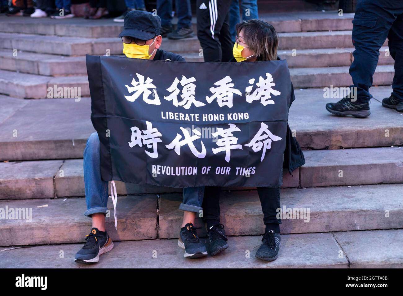 Protesters seen holding the banner that says 'liberate Hong Kong. Revolution of our times' during the demonstration. On October 1st, various anti-China Diasporas in London came together in solidarity against the Chinese Communist Party. Jointly held by Hong Kong Liberty, World Uyghur Congress, Free Tibet and more, speeches were given at Piccadilly Circus to condemn the human rights violations by the CCP. The protestors later marched to the Chinese Embassy in London, where the Chinese National Flag was burnt. (Photo by Belinda Jiao/SOPA Images/Sipa USA) Stock Photo