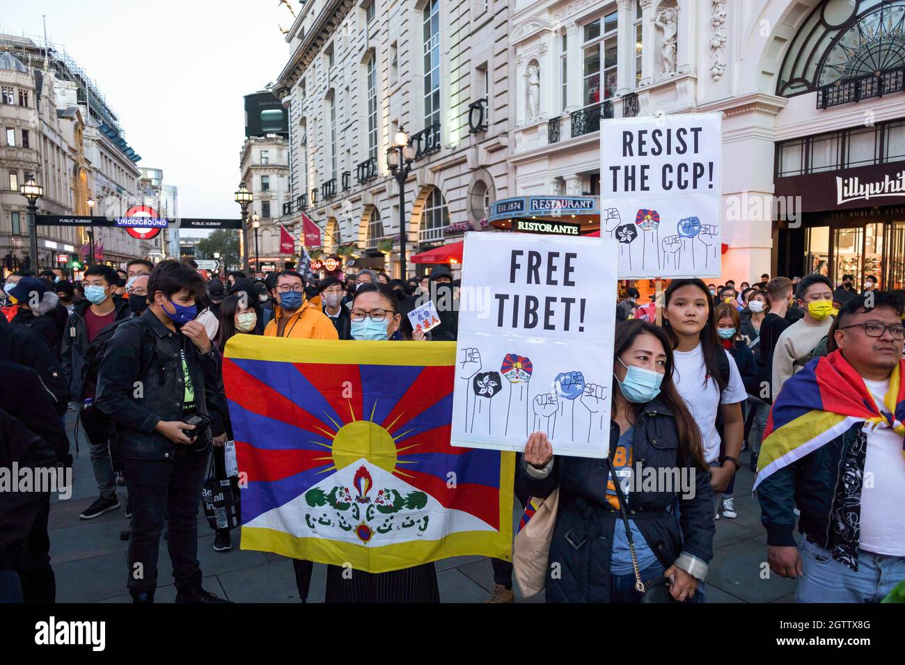 Protesters seen holding a Tibetan flag and placards that say 'Free Tibet!' and 'Resist the CCP' during the demonstration. On October 1st, various anti-China Diasporas in London came together in solidarity against the Chinese Communist Party. Jointly held by Hong Kong Liberty, World Uyghur Congress, Free Tibet and more, speeches were given at Piccadilly Circus to condemn the human rights violations by the CCP. The protestors later marched to the Chinese Embassy in London, where the Chinese National Flag was burnt. (Photo by Belinda Jiao/SOPA Images/Sipa USA) Stock Photo