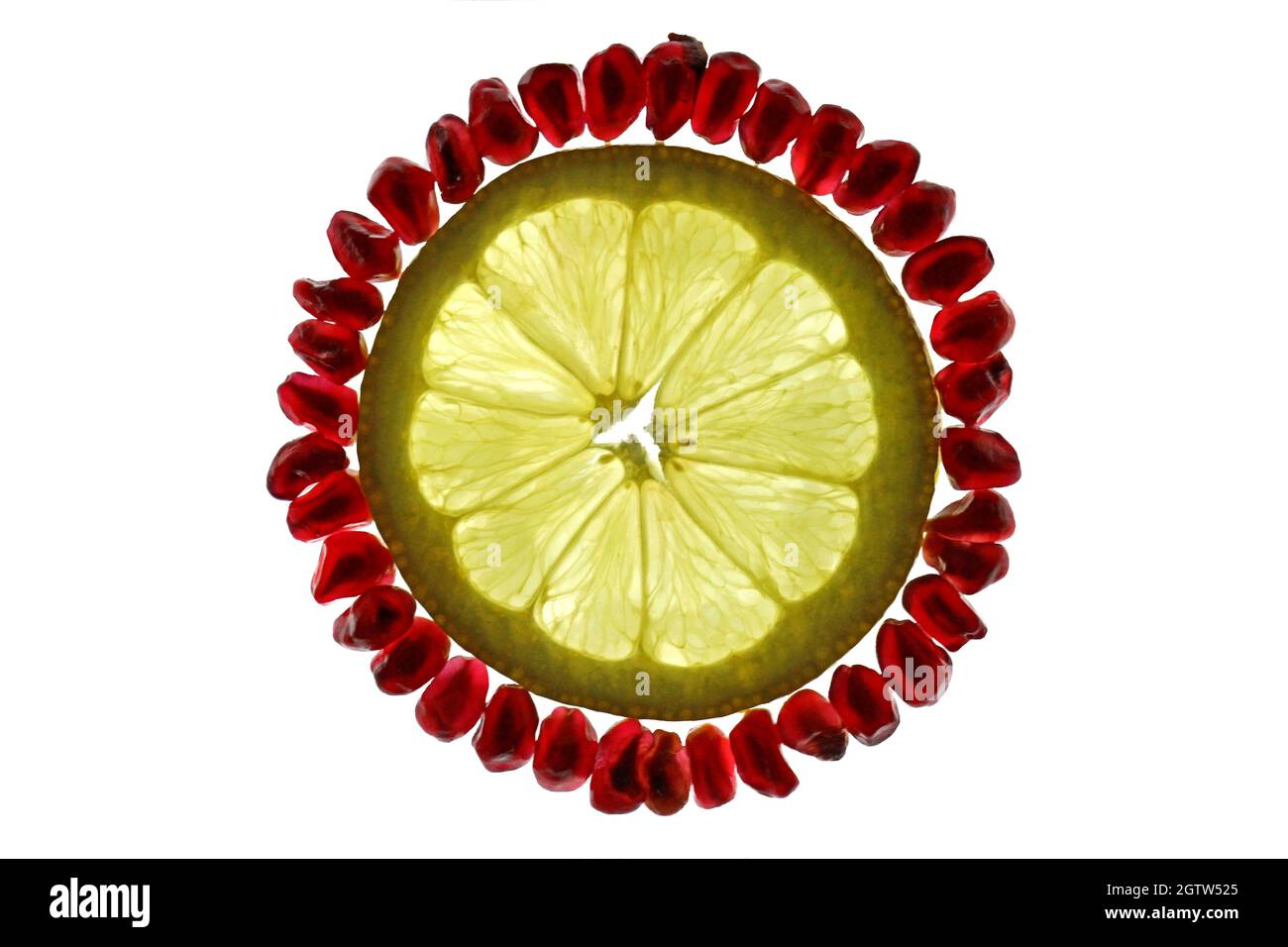 High Angle View Of Pomegranate And Lemon Over White Background Stock Photo