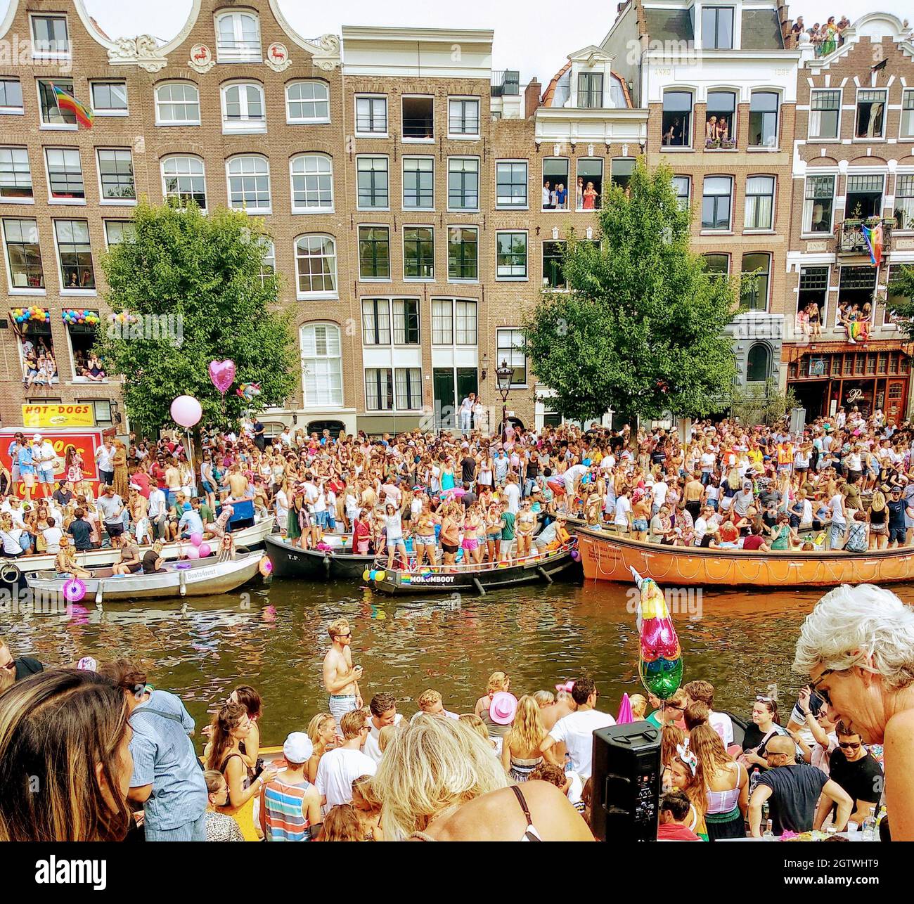 High Angle View Of Crowd On Boats In Canal With Buildings In Background During Stock Photo