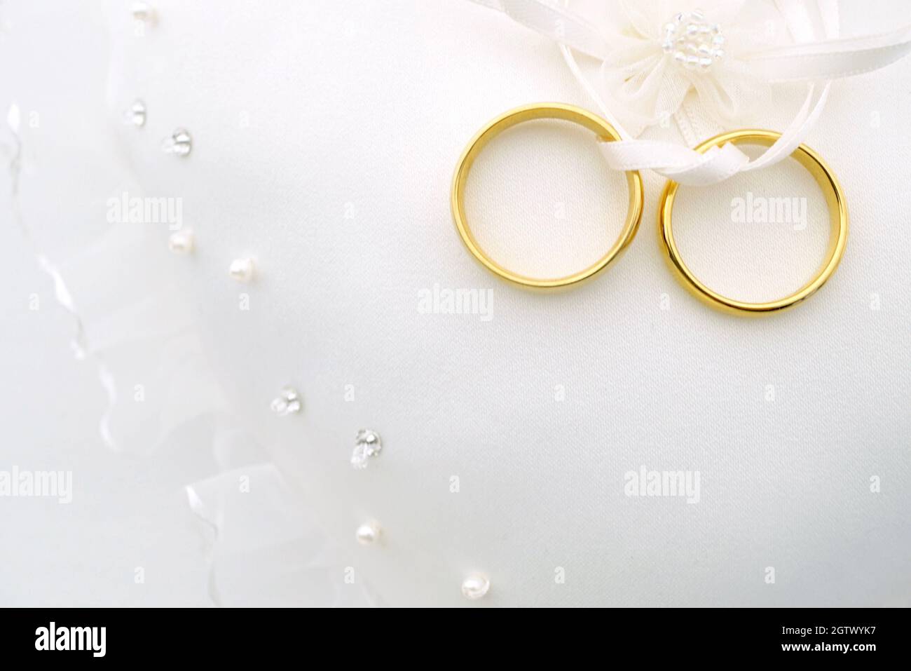 Close-up Of Wedding Rings On Table Stock Photo