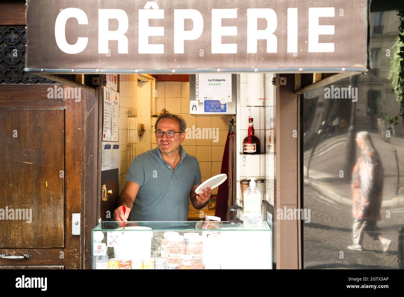 PARIS, FRANCE - Sep 20, 2021: A man working at a creperie in Paris Stock Photo