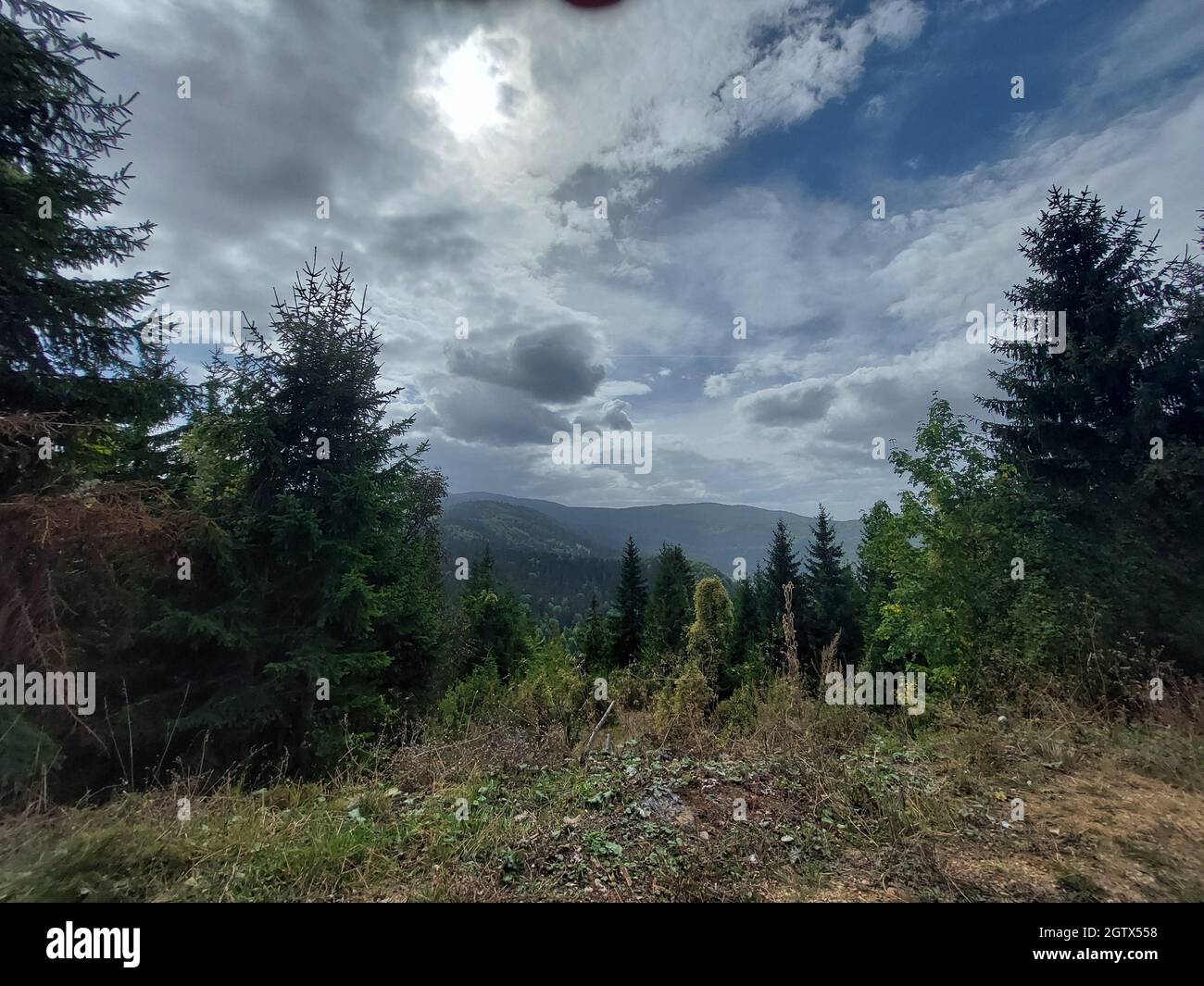 Landscape of hills covered in greenery under a cloudy sky on a gloomy ...