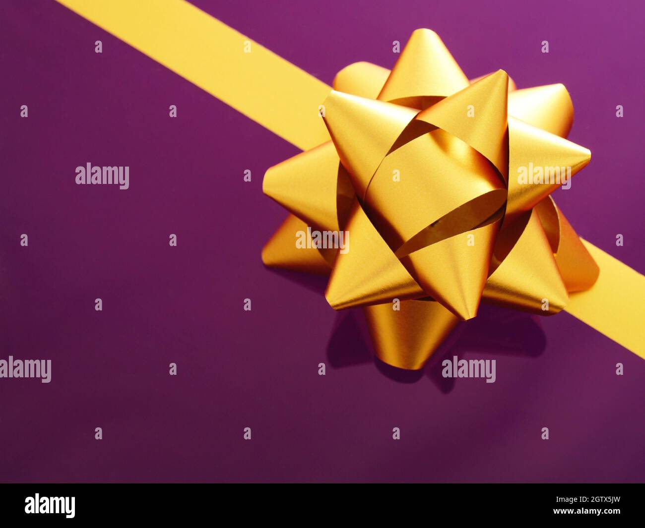Close-up Of Golden Ribbon Tied On Gift Box Stock Photo