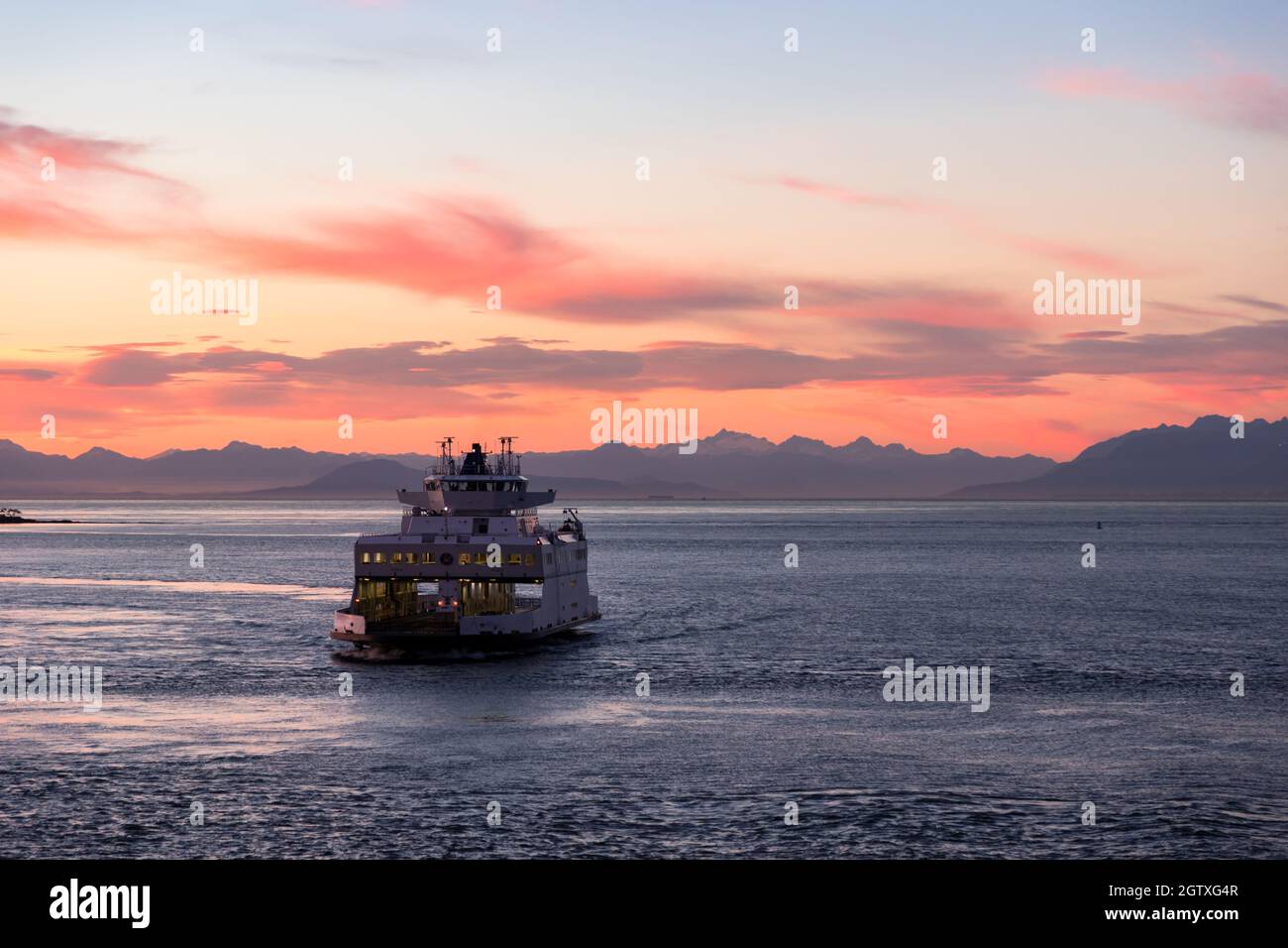 BC Ferry near active pass in the Gulf Islands at sunset. Stock Photo