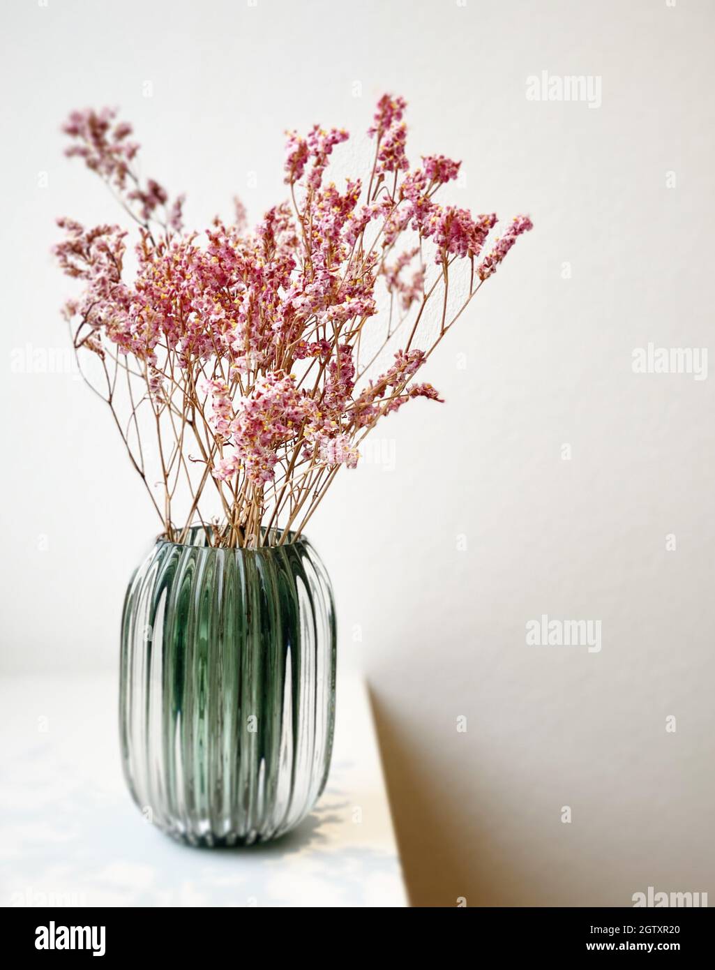 Pink Flowers In Vase On Table Stock Photo