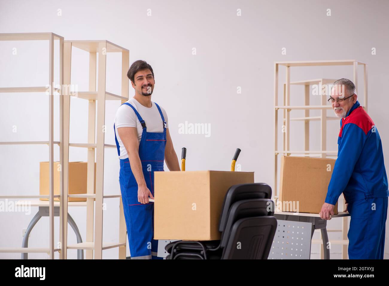 Two professional movers doing home relocation Stock Photo