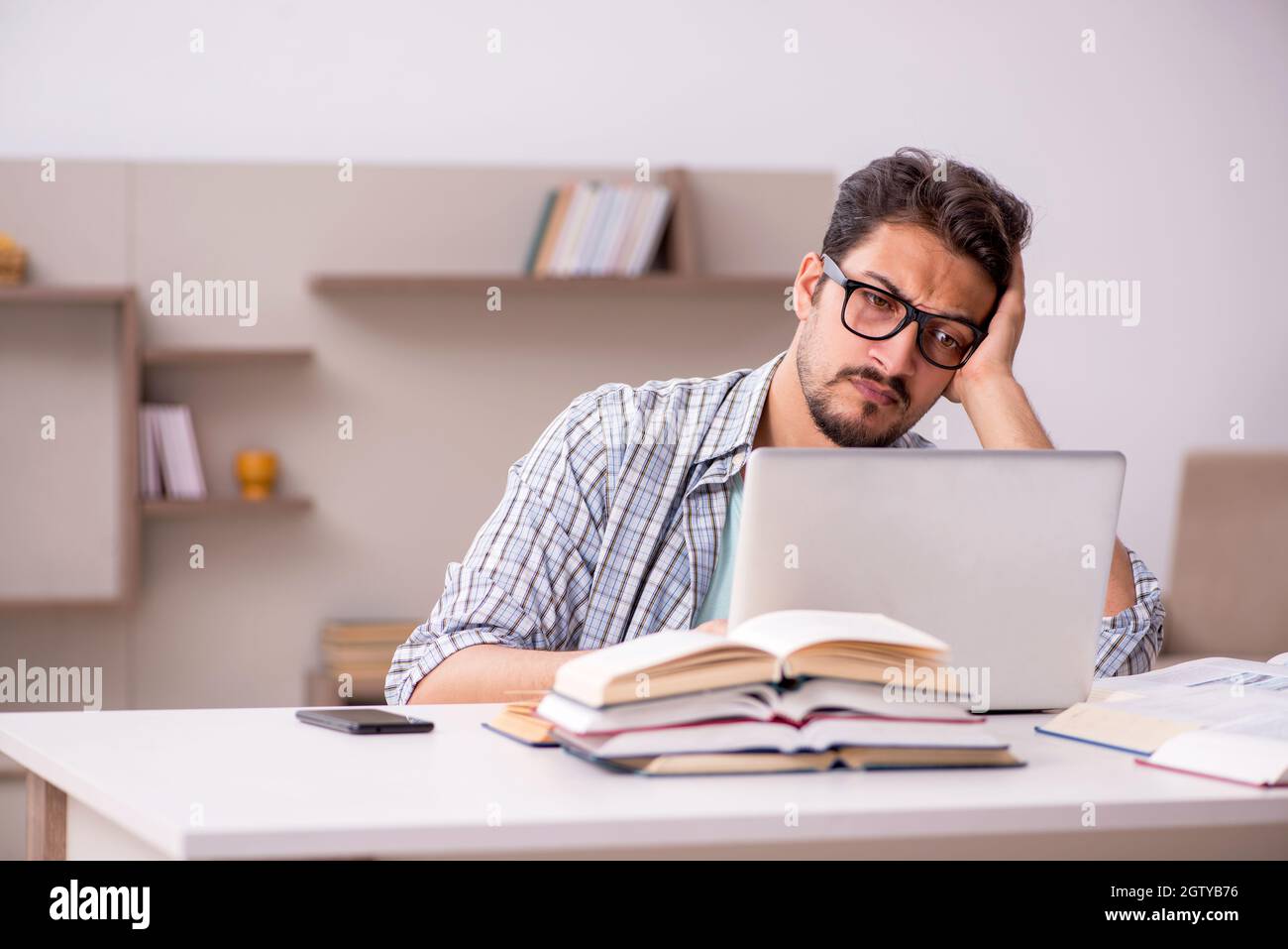 Young student preparing for exams at home Stock Photo - Alamy