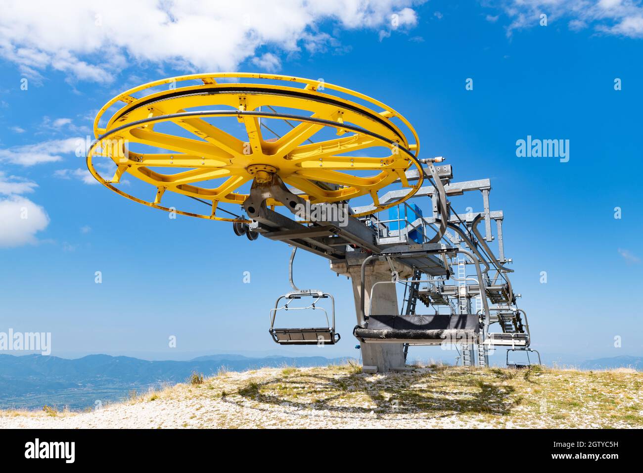 Low Angle View Of Ski Lift On Field Against Blue Sky Stock Photo