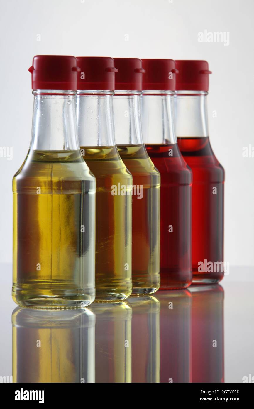 Palm Oil, Sesame Seed Oil, Olive Oil, Grape Seed Oil And Corn Oil In Glass Bottle Over White Stock Photo