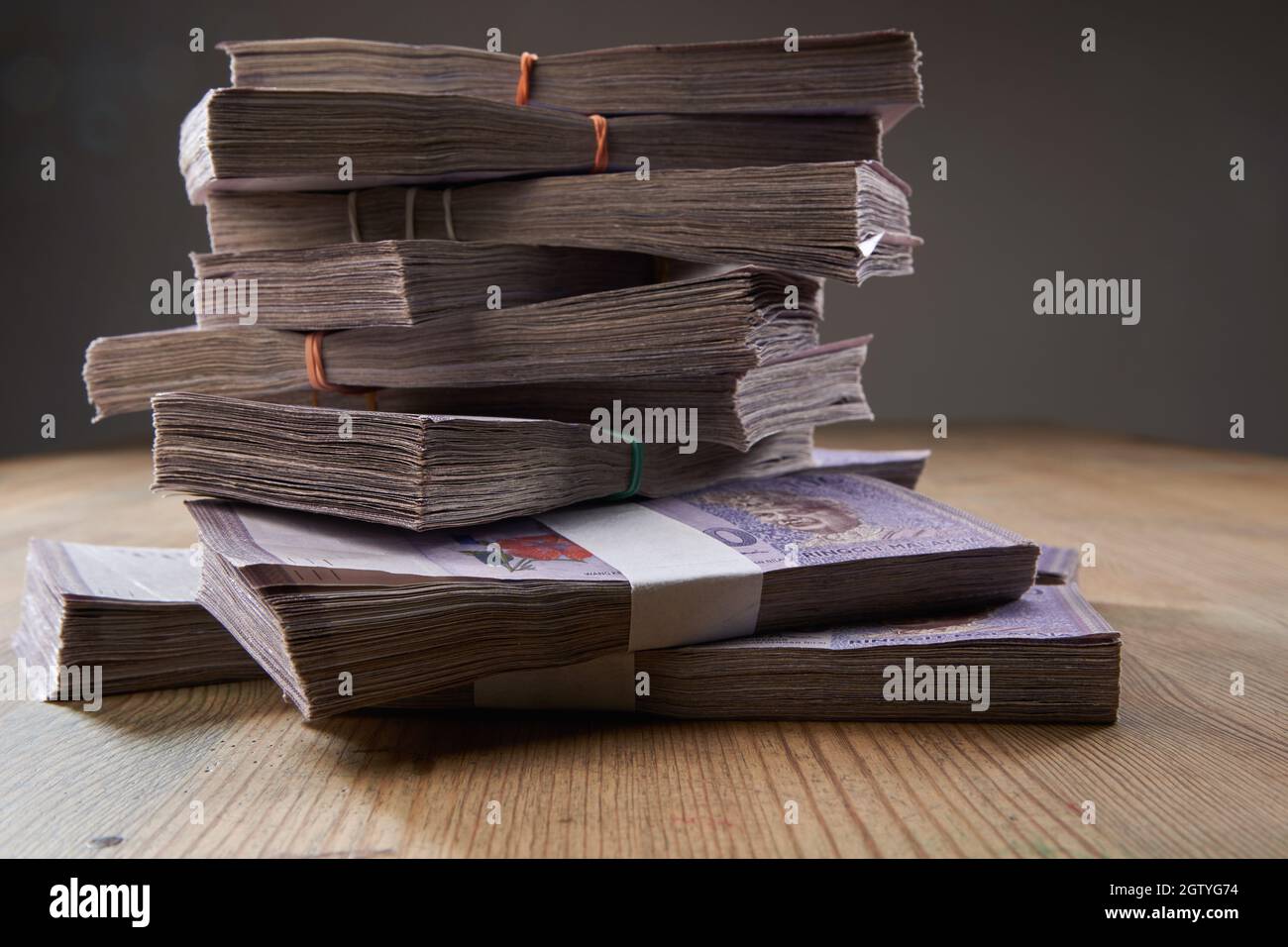 bundles of malaysia currency on the wooden table Stock Photo - Alamy