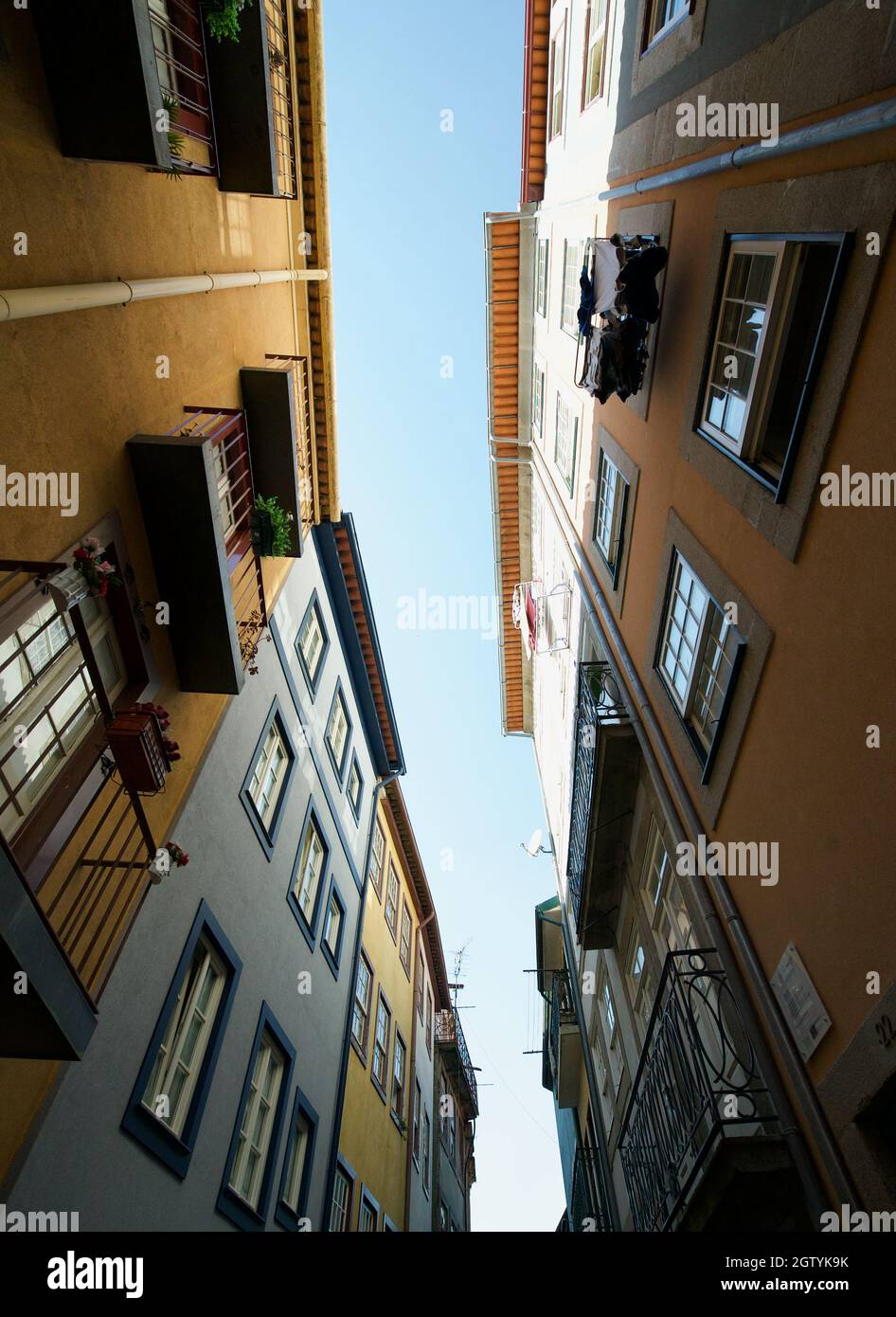 Colorful buildings in Porto, Portugal. Typical Portuguese houses on a side street / road. Multicolored exterior of buildings. Historical apartments. Stock Photo