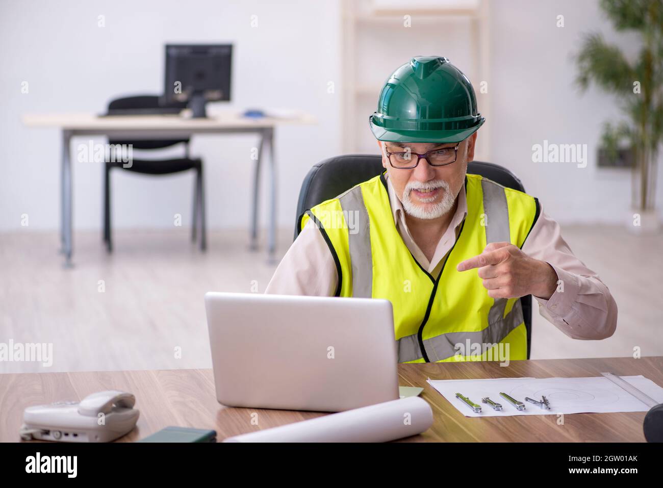 Old architect working in the office Stock Photo