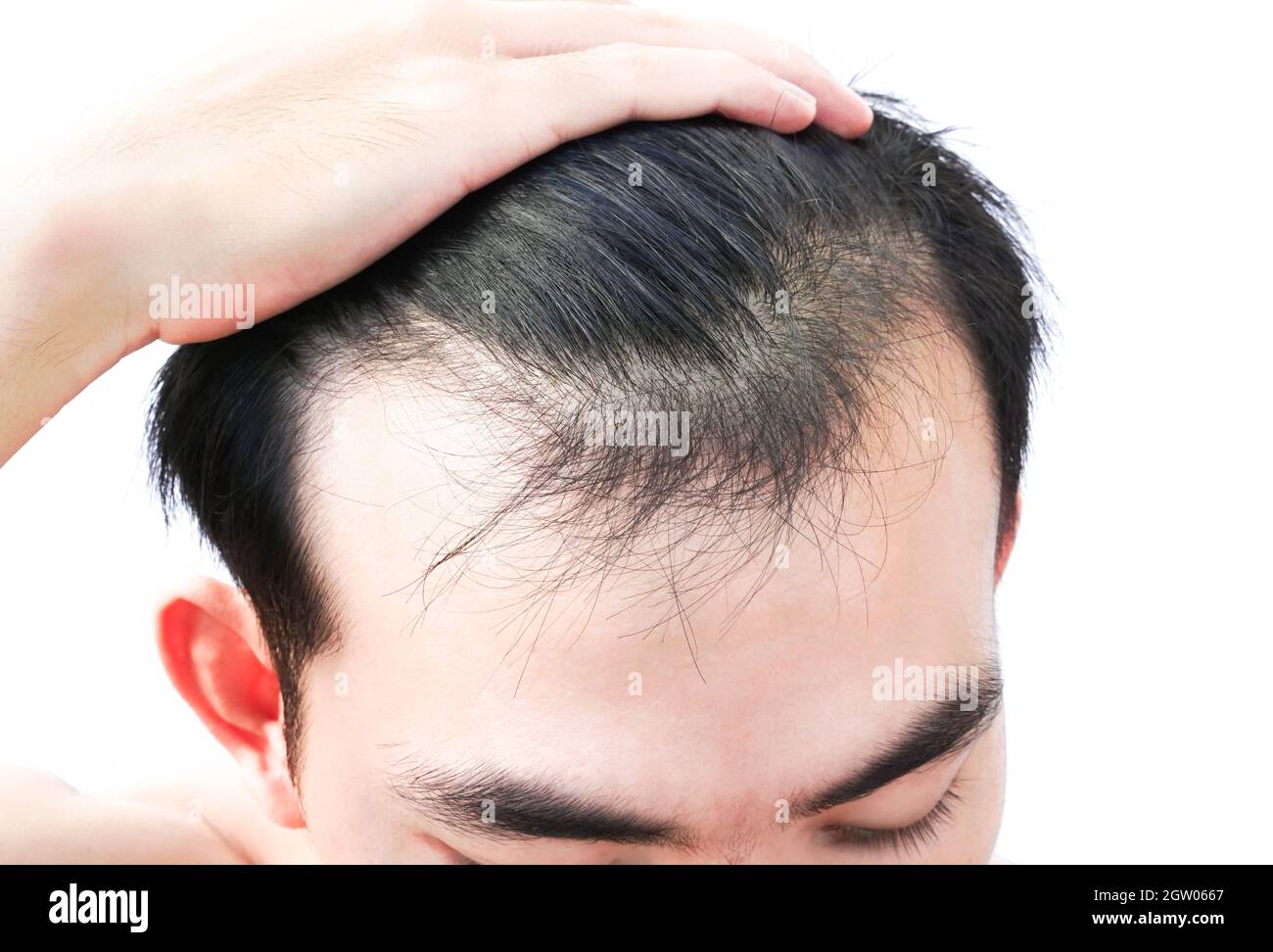 Close-up Of Man With Black Hair Over White Background Stock Photo