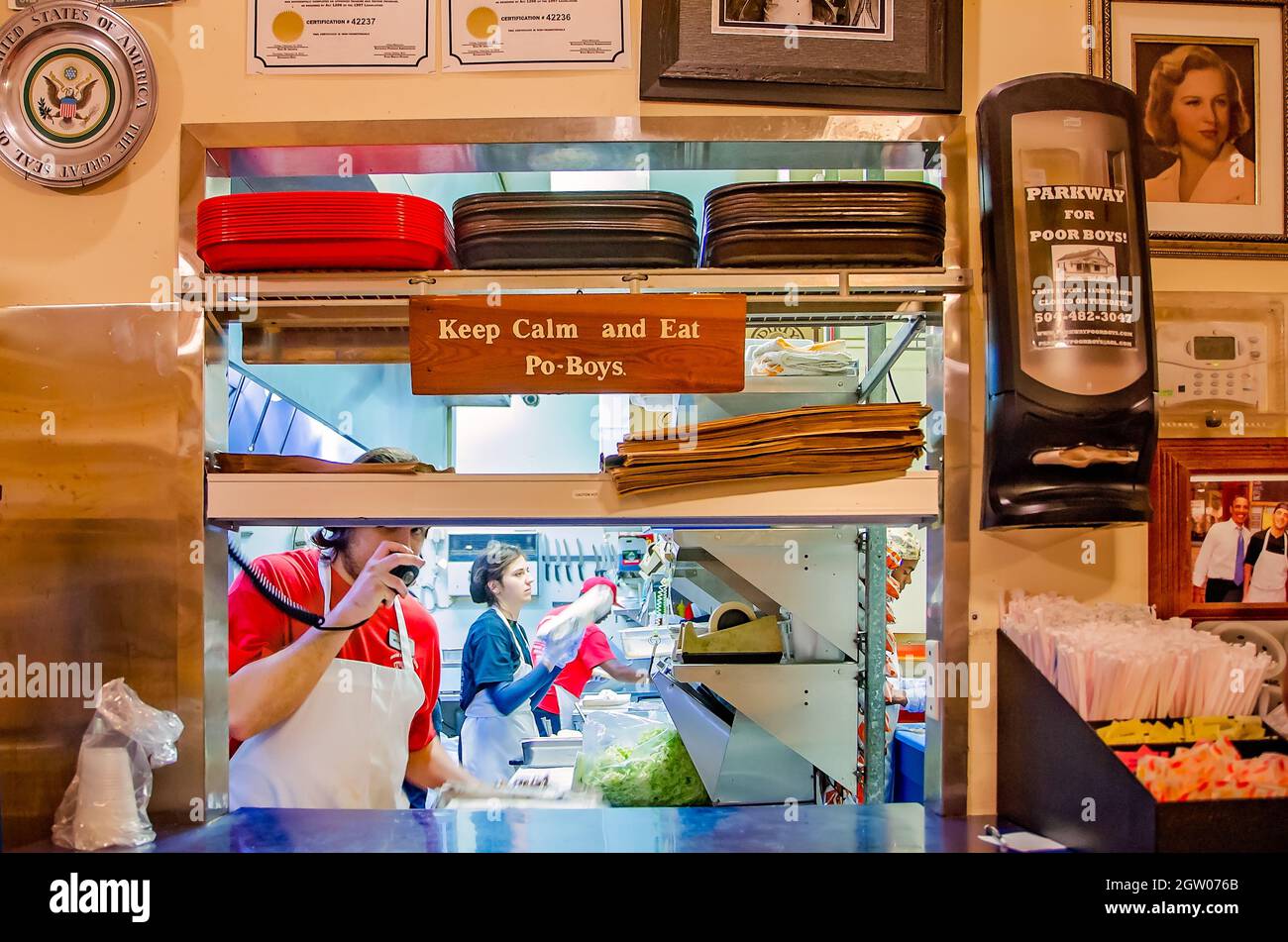 The pick-up window at Parkway Tavern & Bakery features a sign encouraging customers to “Keep calm and eat po-boys,” Nov. 12, 2015, in New Orleans, La. Stock Photo