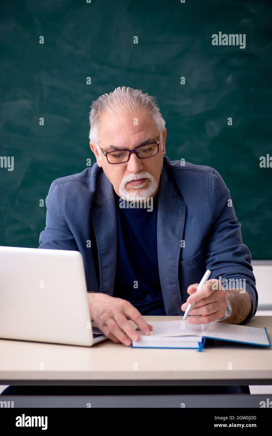 Old teacher in the classroom Stock Photo Alamy