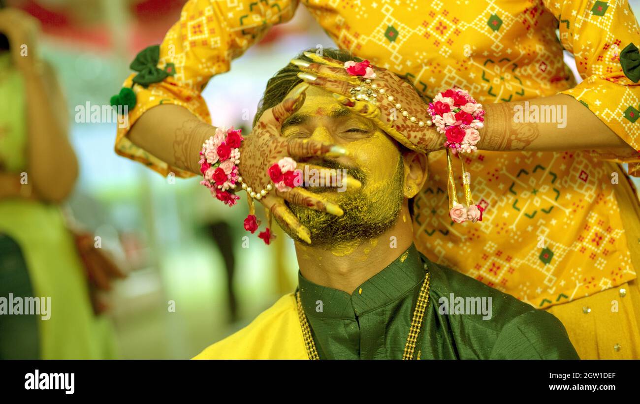 Midsection Of Woman Applying Turmeric On Groom Face In Haldi ...