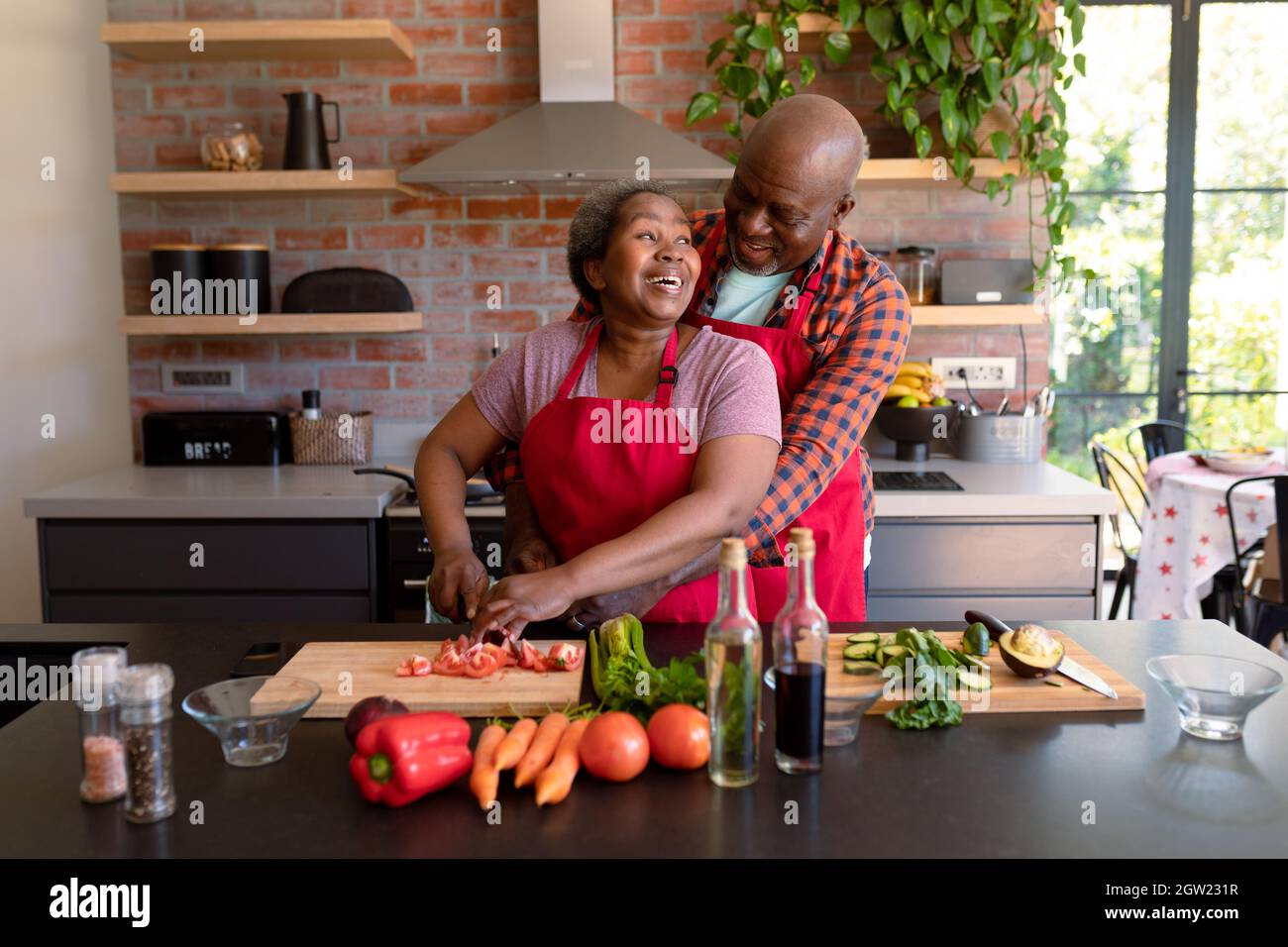 Happy african american senior couple cooking together in kitchen Stock ...