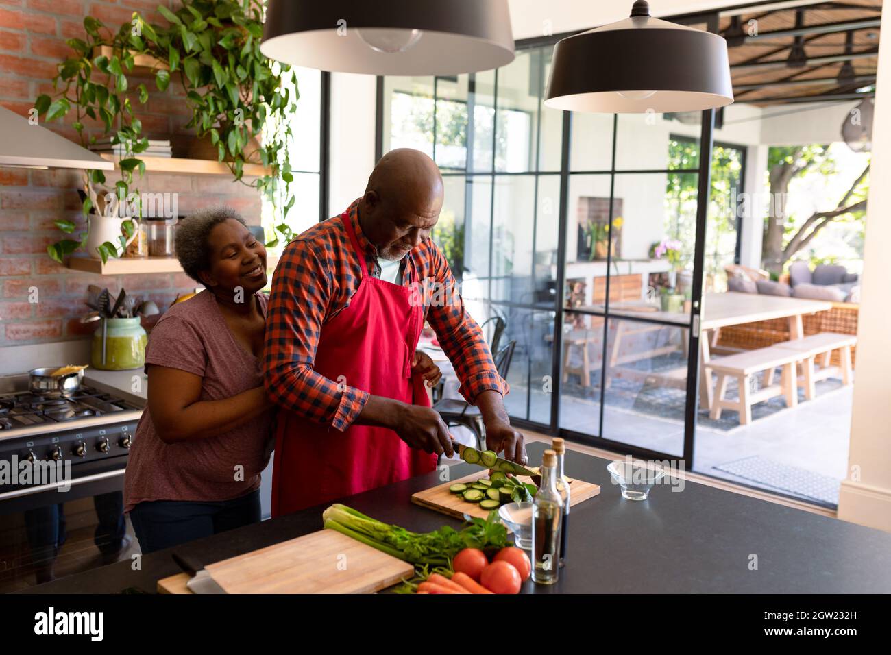 Happy african american senior couple cooking together in kitchen Stock ...