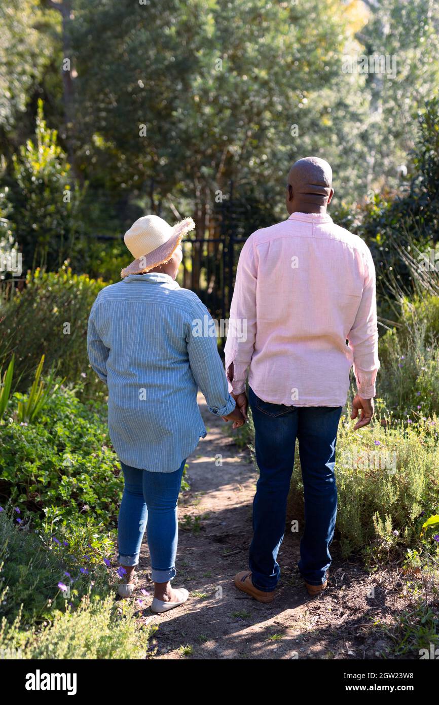 Back view of happy african american senior couple holding hands ...