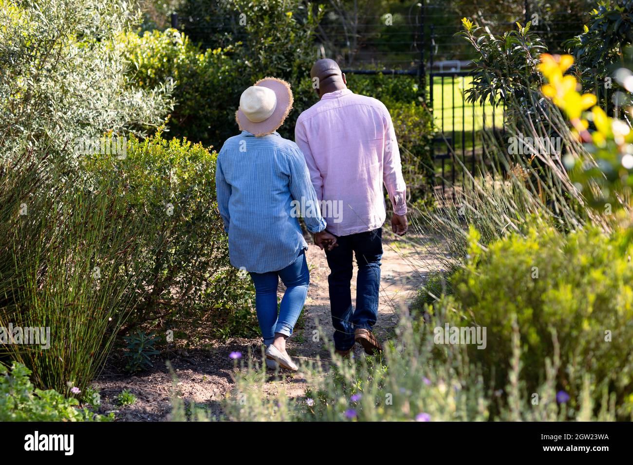 Back view of happy african american senior couple holding hands ...