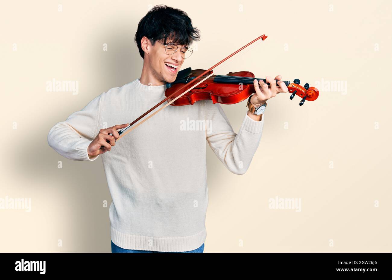 Handsome hipster young man playing violin smiling and laughing hard out loud  because funny crazy joke Stock Photo - Alamy