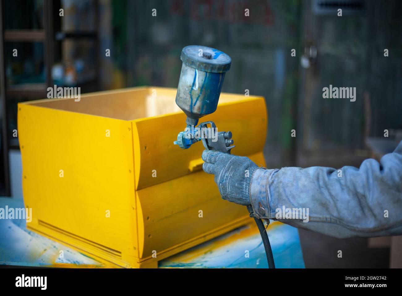 Painting Hives For Bees. Work In The Spray Paint On A Wooden