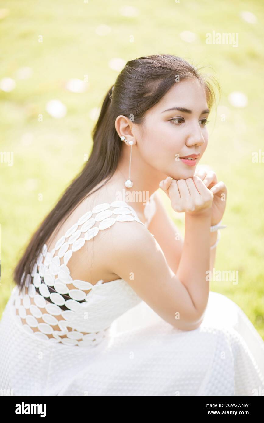 Close-up Of Woman With Hand On Chin Looking Away Stock Photo