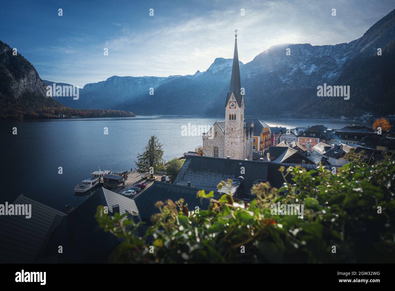 Hallstatt beautiful view with Lake, Church and Alps Mountains - Hallstatt, Austria Stock Photo