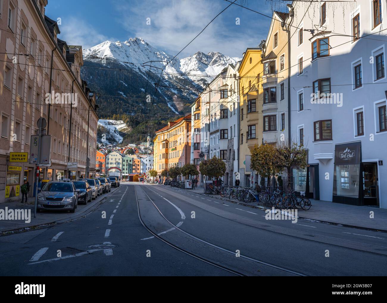 Street view of Innsbruck Old Town with Alps Mountains on background - Innsbruck, Tyrol, Austria Stock Photo
