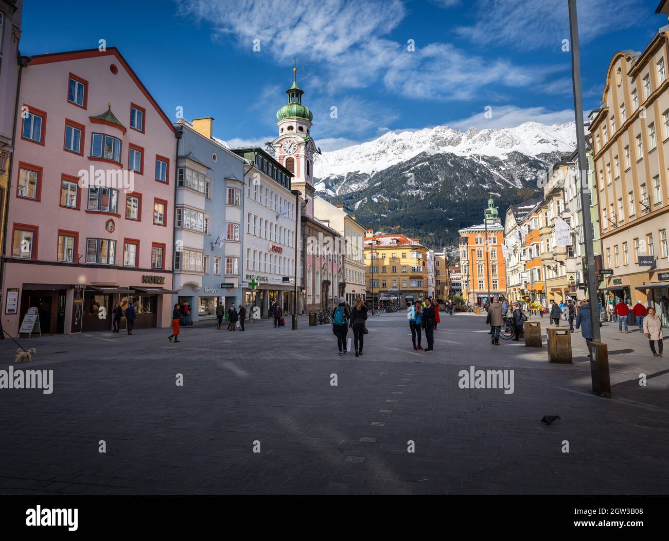 Street view of Maria-Theresien-Strasse with Alps Mountains on background - Innsbruck, Tyrol, Austria Stock Photo