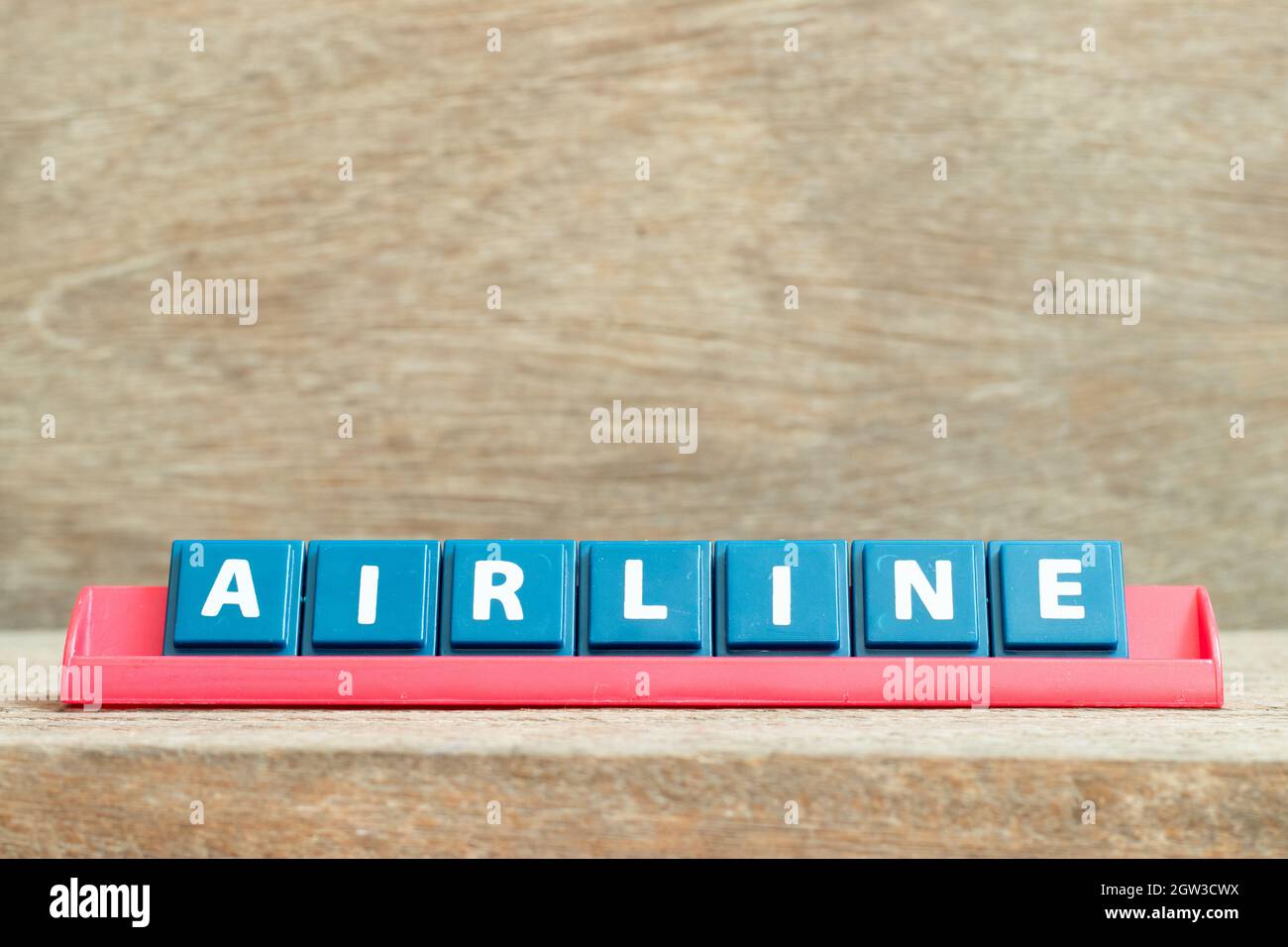 Tile alphabet letter with word airline in red color rack on wood ...