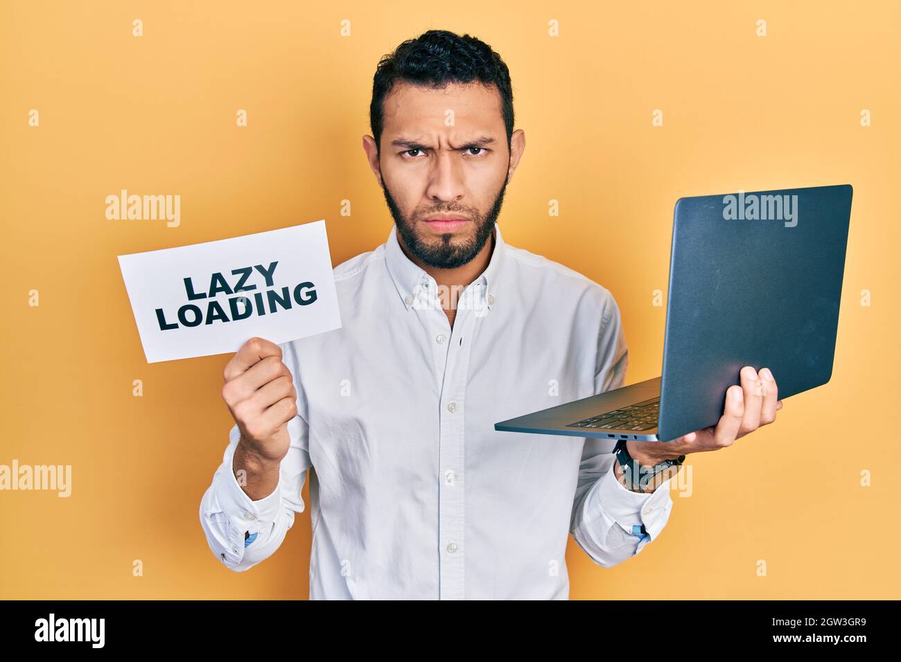 Lazy Computer Use Hispanic man with beard working using computer laptop holding lazy ...