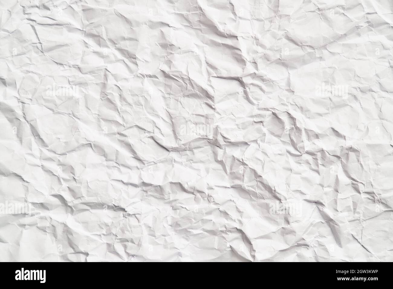 White crumpled paper texture with wrinkles. Damaged and torn sheet