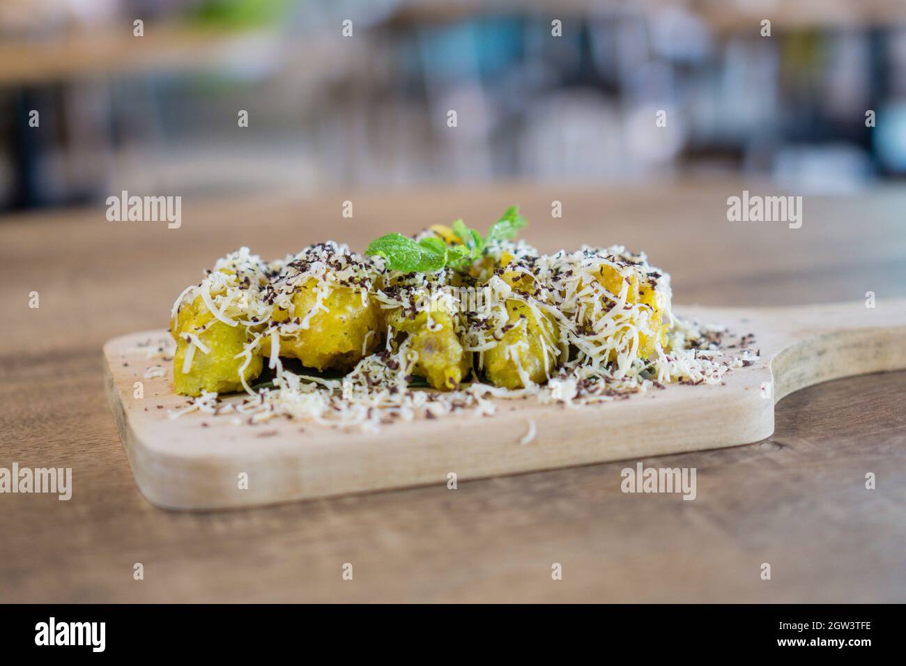 Pisang Goreng Keju Is A Malaysian And Indonesian Delicacy Banana Fritters Topped With Plenty Of Cheese Grated Chocolates And Condensed Milk Stock Photo Alamy