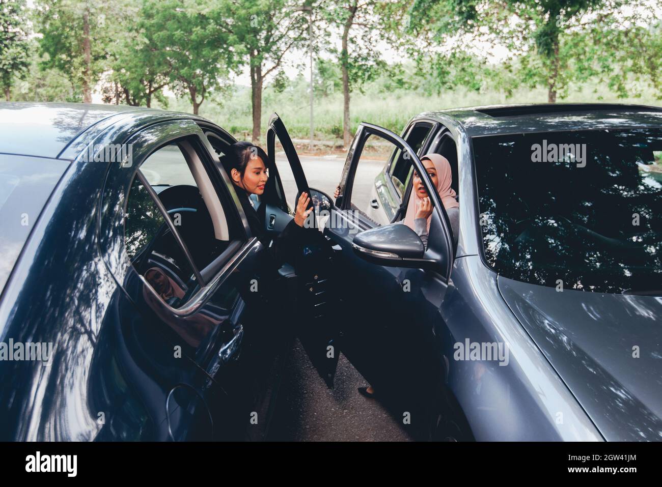 Women Opening Car Doors Stock Photo - Alamy