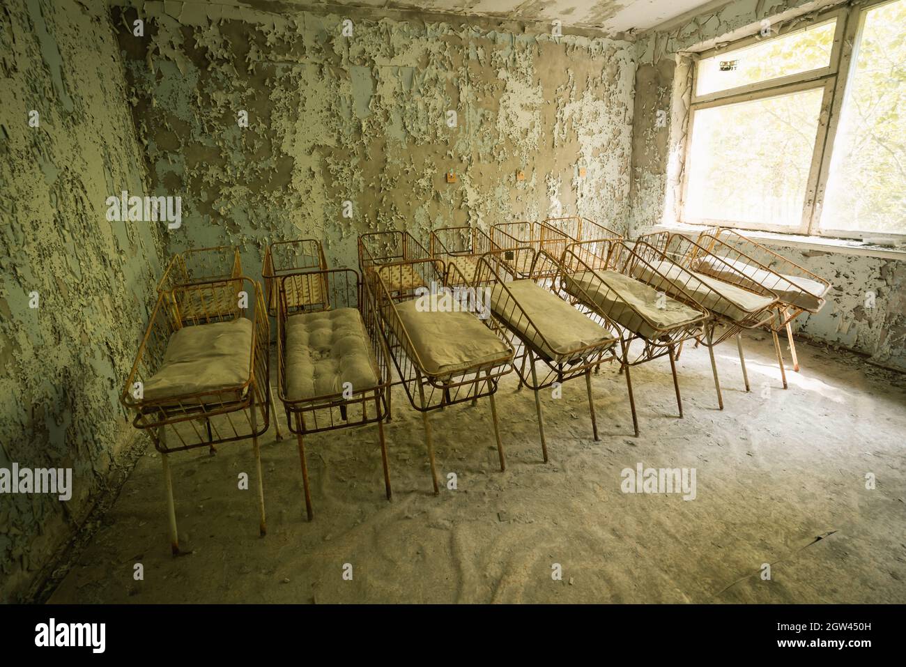 Cribs at the Nursery of Pripyat Hospital - Pripyat, Chernobyl Exclusion Zone, Ukraine Stock Photo