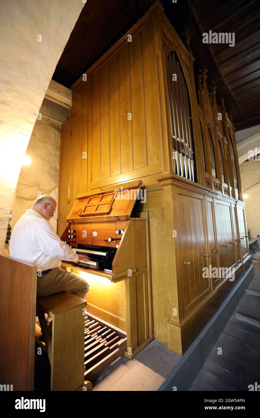 Rostock Biestow, Germany. 30th Sep, 2021. Wolfram Hausberg, organist, plays in the fieldstone church in Rostock-Biestow on the restored Friese organ from 1870, which will be officially inaugurated on 03.10.2021. The organ by Friedrich Friese (1827-1896) from Mecklenburg is one of the few instruments that are completely preserved in the original. Credit: Bernd Wüstneck/dpa-Zentralbild/dpa/Alamy Live News Stock Photo