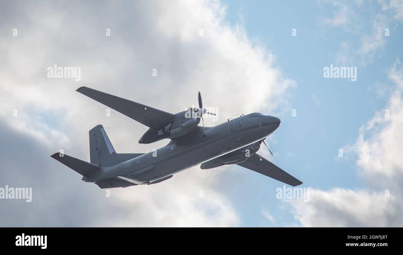 A twinengine military transport aircraft performs a flight Stock Photo